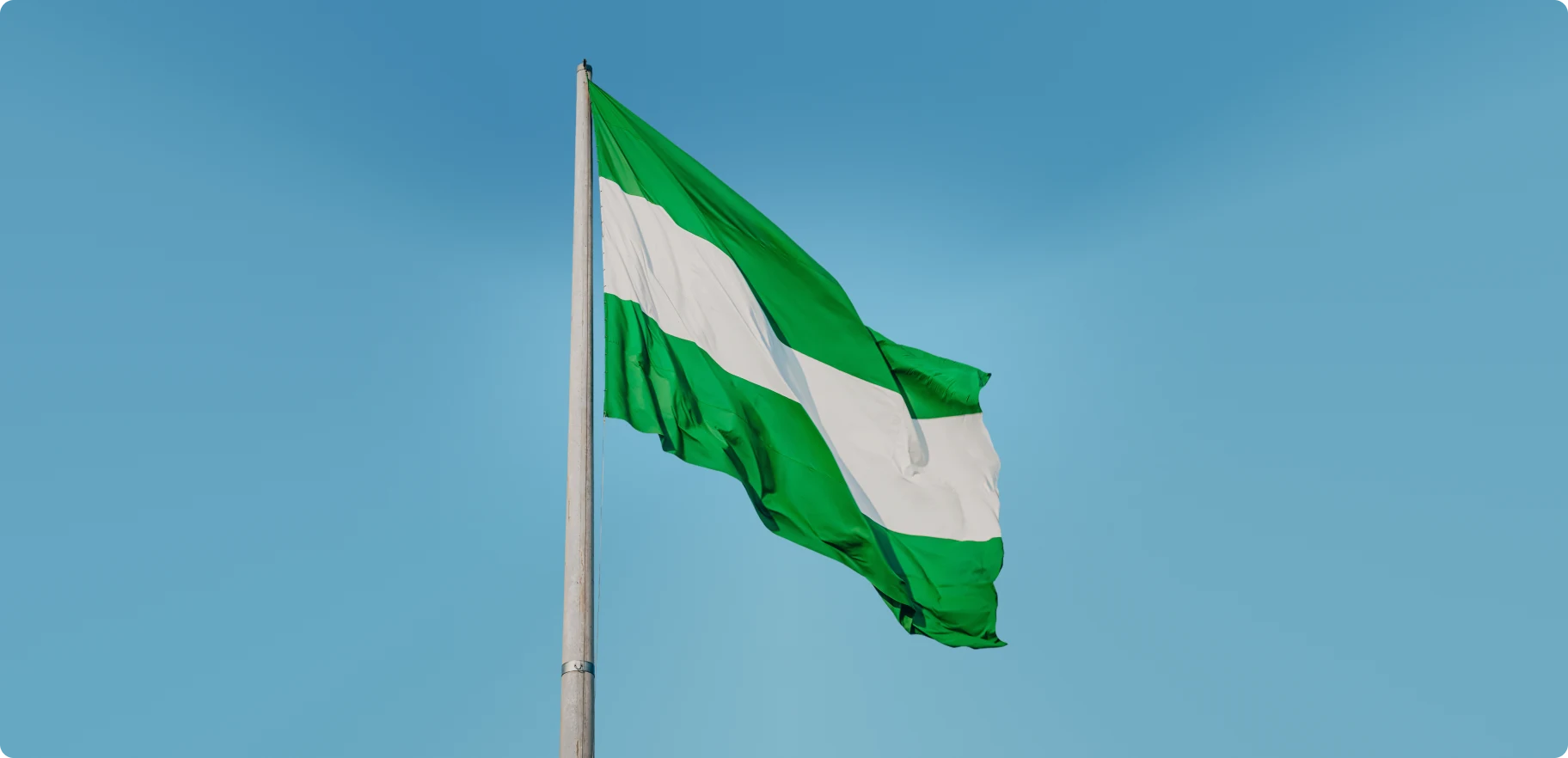 The Nigerian flag against a blue sky